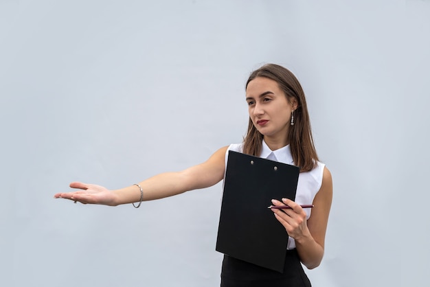 Business woman in white shirt holding document on clipboard, isolated on a white background.