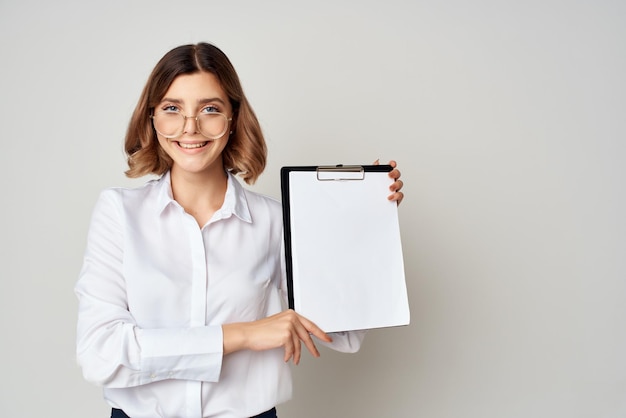 Business woman in white shirt with documents in hands emotion work success