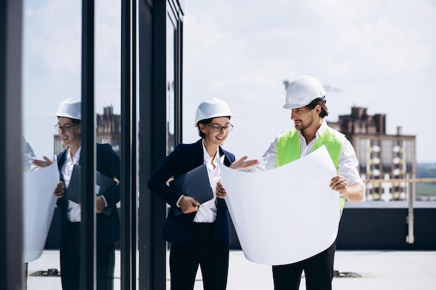 business woman with architect talking on the roof of the construction building