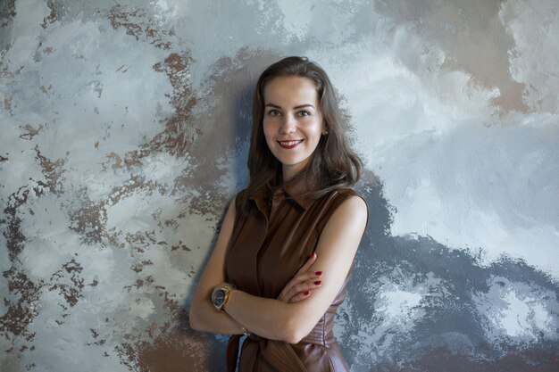 Business woman with brown hair in a brown dress