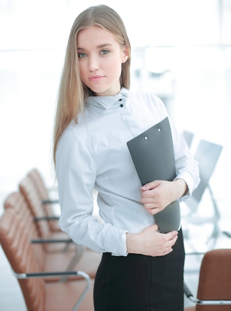 Business woman with documents on the background of the office