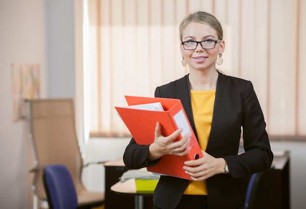 Business woman with folder in hands at office