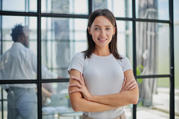 Business woman with her staff in background at office