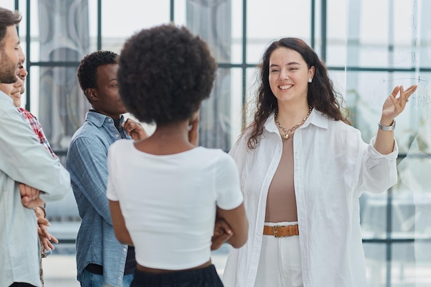 business woman with her staff in background at office