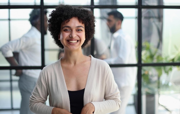 Business woman with her staff in background at office