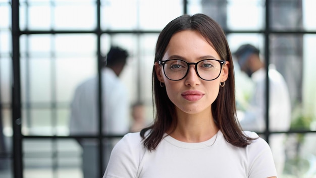 Business woman with her staff in background at office