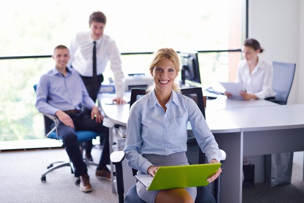 business woman  with her staff,  people group in background at modern bright office indoors