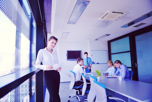 business woman  with her staff,  people group in background at modern bright office indoors