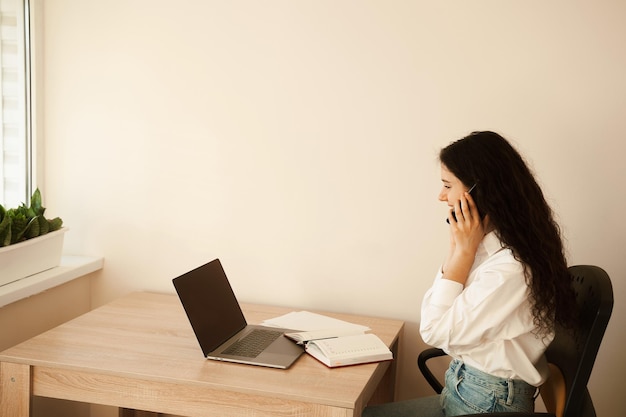 Деловая женщина с ноутбуком, работающая онлайн на внештатной работе Привлекательная девушка смотрит онлайн-видеоурок о работе дизайнера