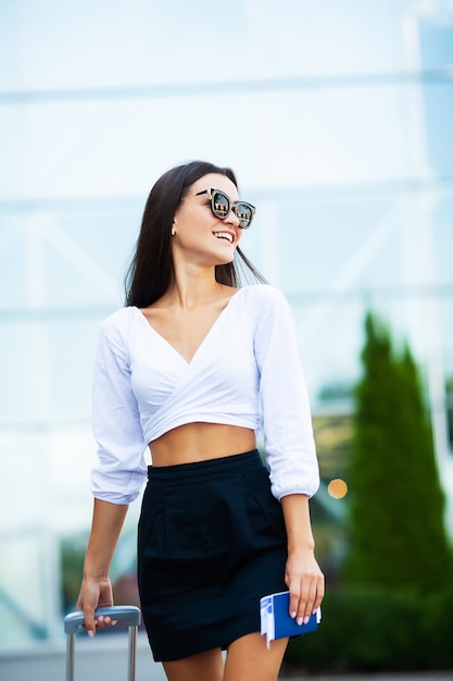 Business woman with passport and tickets near airport