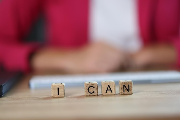 Business woman word i can from cubes in office motivation goal and success achievement