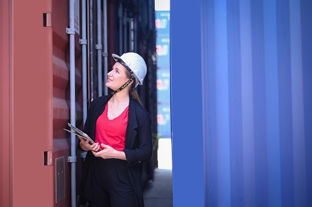 Business woman Work in an international shipping yard area Export and import delivery service with containers