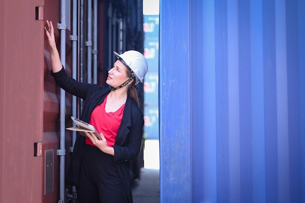 Business woman work in an international shipping yard area\
export and import delivery service with containers