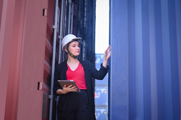 Business woman Work in an international shipping yard area Export and import delivery service with containers