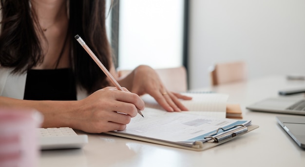 Business woman working in finance and accounting analyzes financial budget at home office