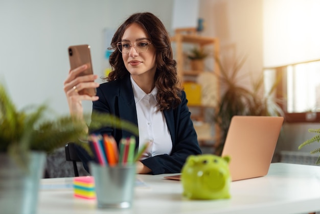 Business woman working from home. Business woman using phone at home for work3