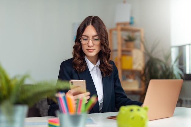 Business woman working from home. Business woman using phone at home for work