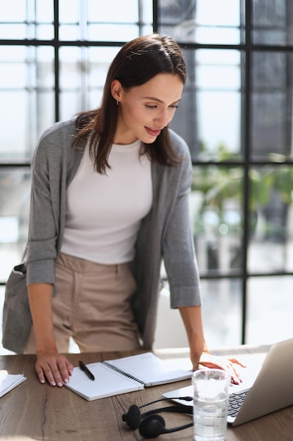 Business woman working on laptop computer in office