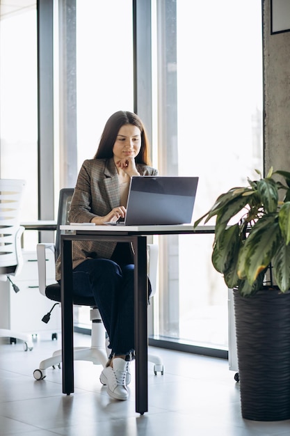 Business woman working on laptop in office