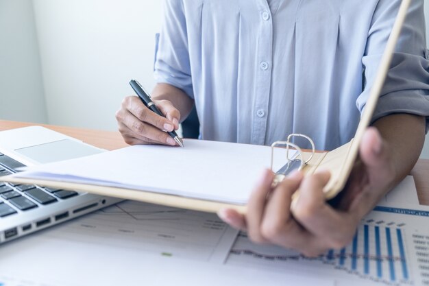 Photo business woman working at office with laptop and documents on his desk. business concept.