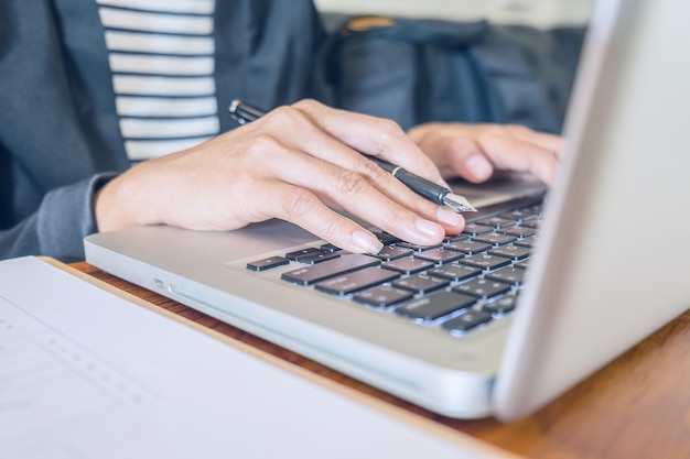 Business woman working at office with laptop and documents on his desk. Business concept.