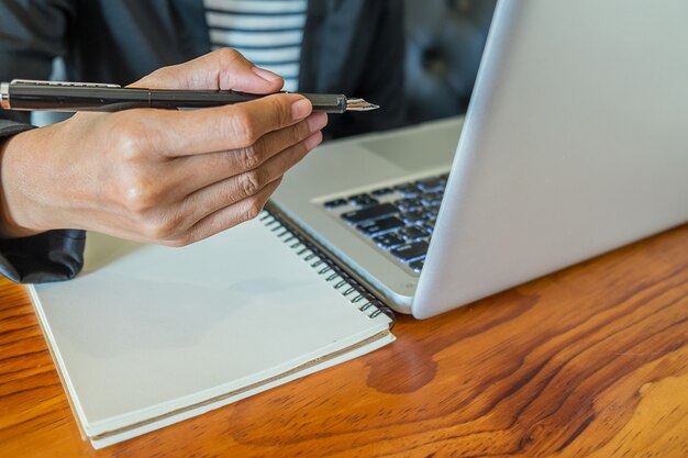 business woman working at office with laptop and documents on his desk. business concept.