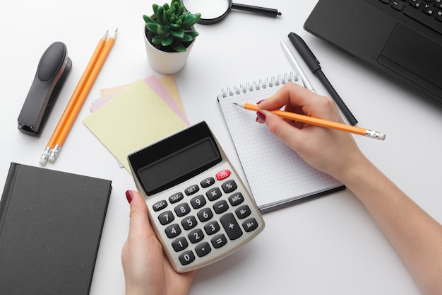 Business woman working with financial data hand using calculator