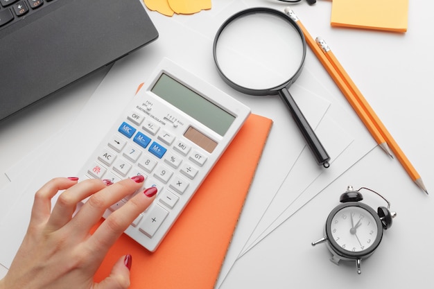 Business woman working with financial data hand using calculator