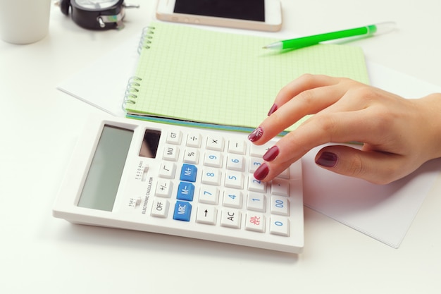 Business woman working with financial data hand using calculator