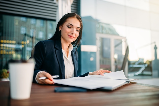 business woman works at lunch in cafe