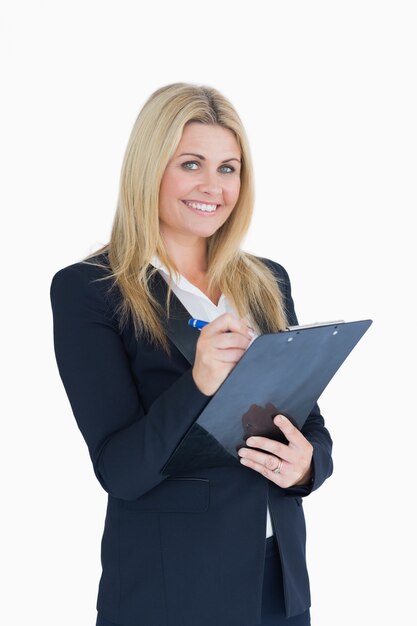 Business woman writing on clipboard