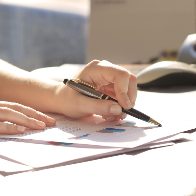 Business Woman Writing with pen in the office