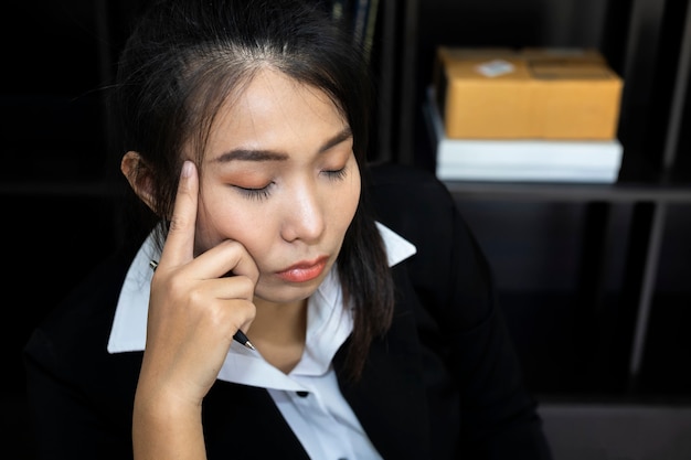 A business women are stressed in the work. When the malfunction by removing the hands clasping head.
