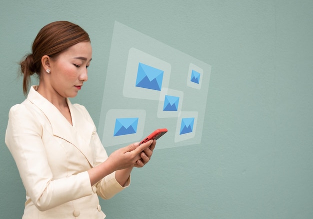 A business women check email on the mobile phone email blue icon virtual screen media and connection concept copy space