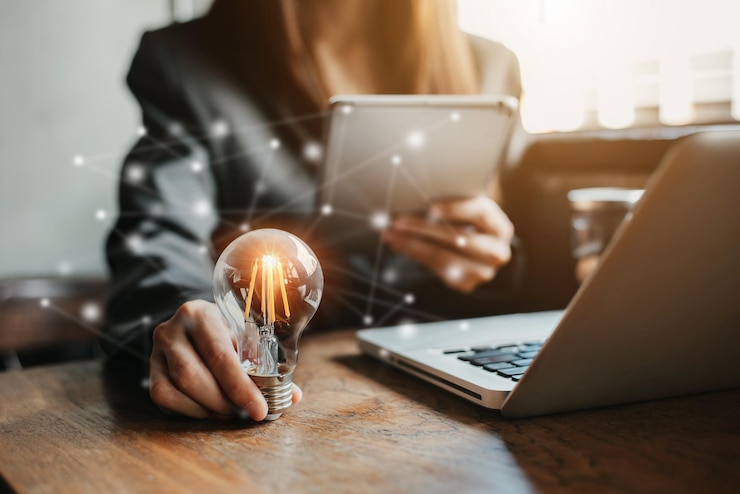 Photo business women entrepreneurs show creative business strategies with light bulbs as a concept.