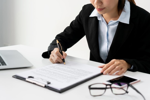 Business women hand signing a contract on document at office Contract and partnership Concept