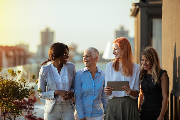 Business women having a conversation on the rooftop.