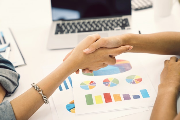 Business women shaking hands