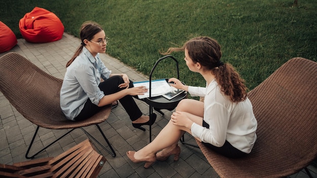 Business women speaking outside