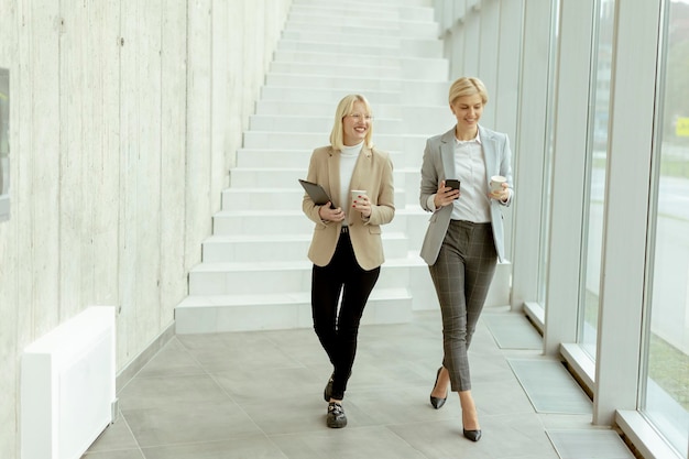 Business women walking in the office corridor