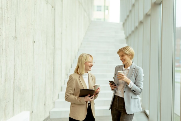 Business women walking in the office corridor