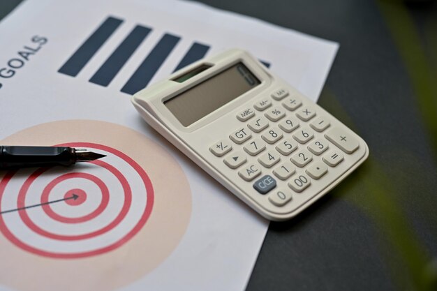 Business workspace top view with calculator pen and business goals planning report