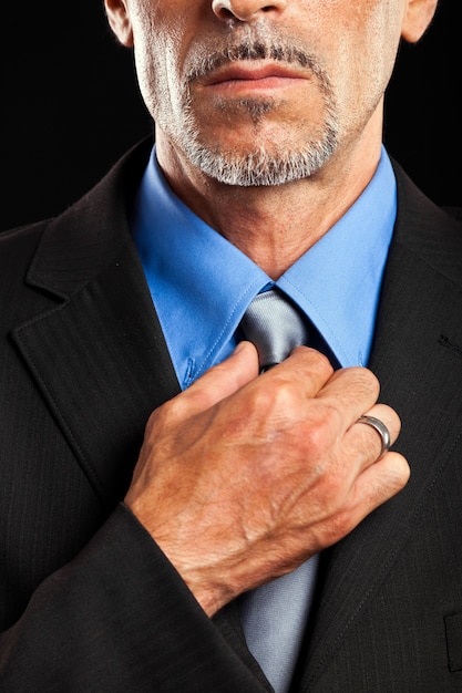 Businessman adjusting his collar 