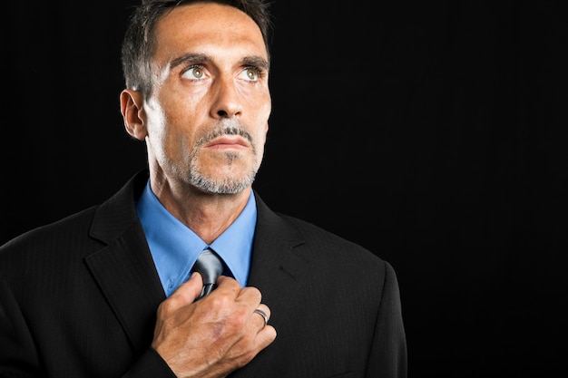 Businessman adjusting his tie