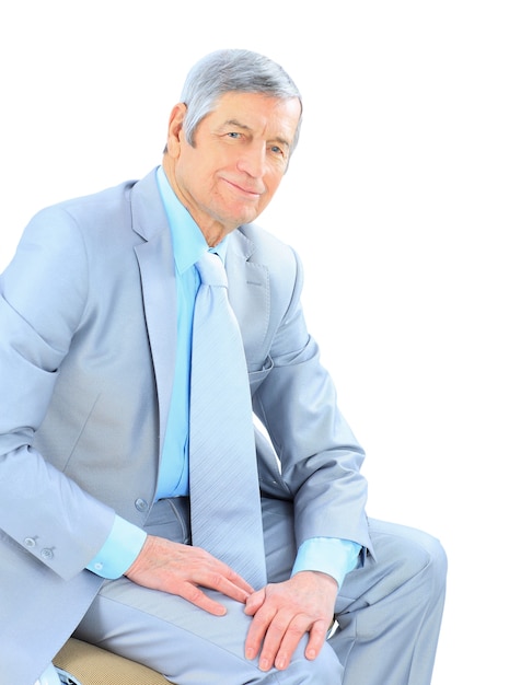 Businessman in age, resting for a break. Isolated on a white background.