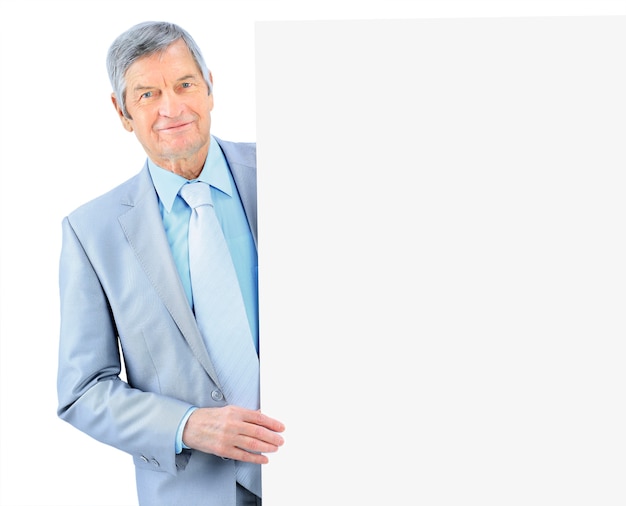 The businessman at the age of with a poster to advertise. Isolated on a white background.