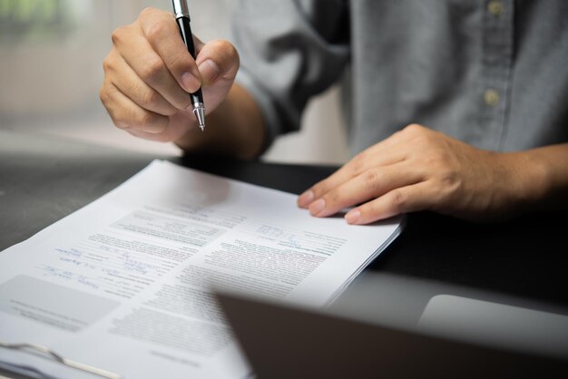 businessman agree to make deal signing document sale contract or legal transaction contract at desk