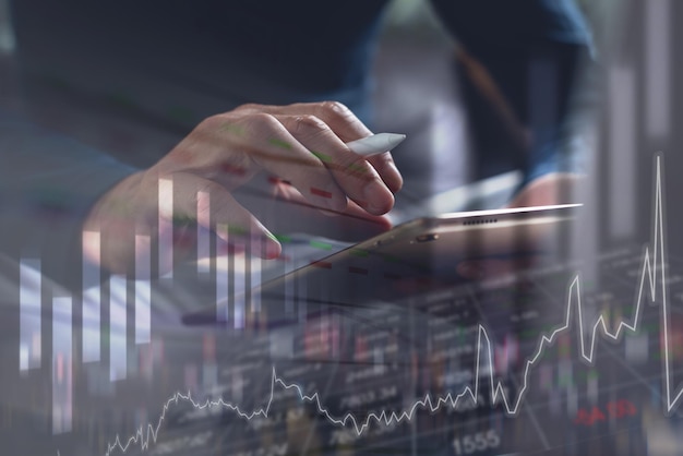 Photo businessman analyzing business data on laptop computer with financial graph on virtual screen