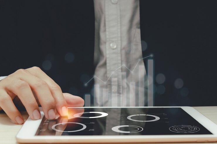 Businessman analyzing graphs and charts report profit and growth statistics in tablets.Focus hand