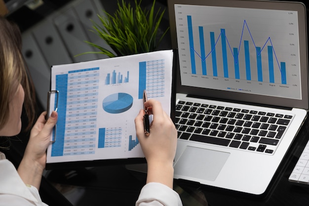 Businessman analyzing investment charts with laptop. Accounting